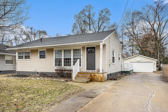 view of front of home featuring a garage, a shingled roof, a chimney, and an outdoor structure