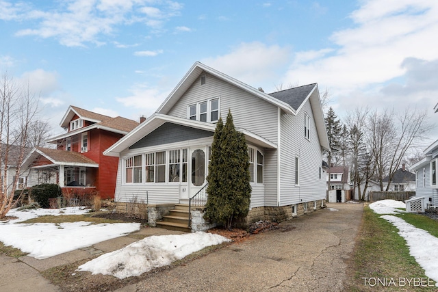 bungalow featuring entry steps and driveway