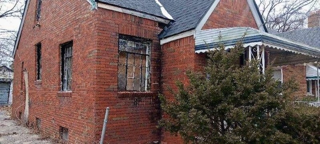 view of side of property featuring brick siding