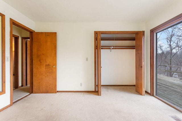 unfurnished bedroom with visible vents, baseboards, a closet, and carpet flooring