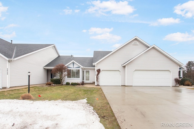 view of front facade with driveway, a garage, and a front yard