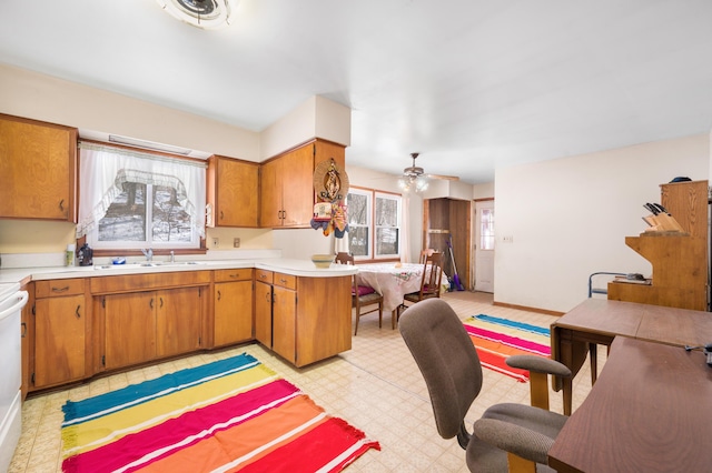 kitchen featuring light floors, a healthy amount of sunlight, a peninsula, and light countertops