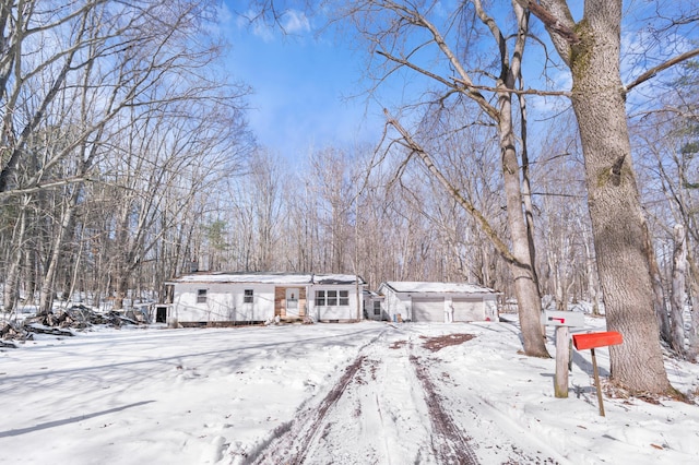 view of front of home with a detached garage