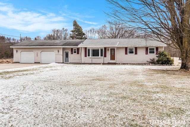 single story home with driveway and a garage