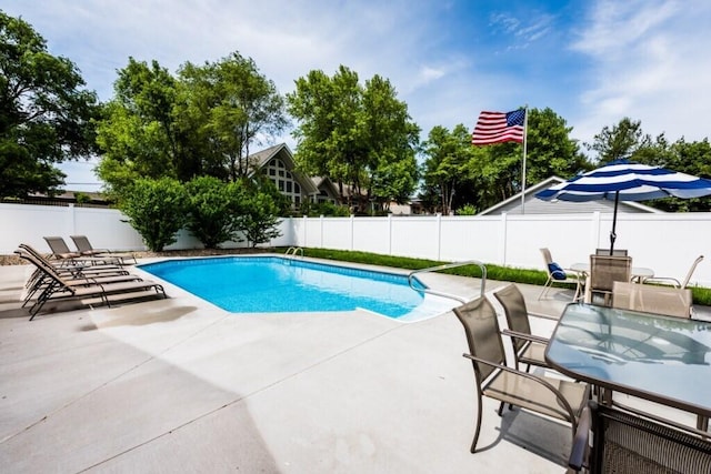 view of swimming pool with a patio, outdoor dining space, a fenced backyard, and a fenced in pool