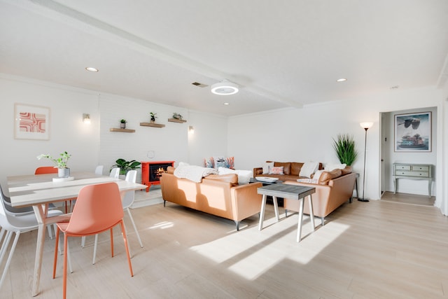 living area featuring crown molding, light wood-type flooring, visible vents, and recessed lighting