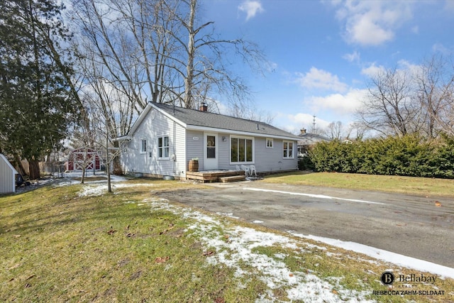 view of front of property with a front lawn and a chimney