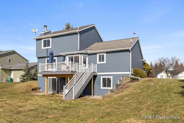 rear view of house featuring a deck, a yard, stairway, and a chimney