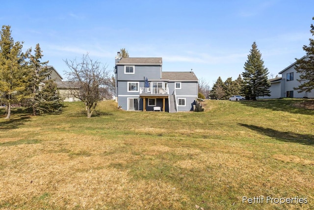 back of property with a lawn and a wooden deck