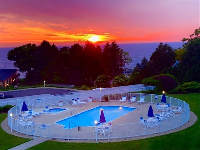 4144 Ridge Rd Unit 16, Stevensville, MI 49127 - pool at dusk with a community hot tub, a patio, a community pool, and a water view