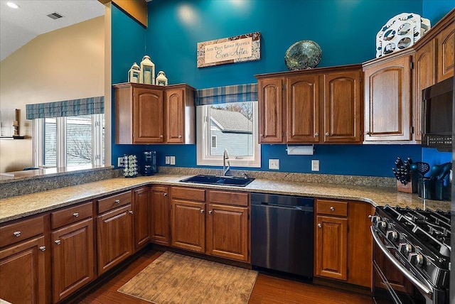 4144 Ridge Rd Unit 16, Stevensville, MI 49127 - kitchen featuring dishwasher, gas range oven, a sink, black microwave, and vaulted ceiling