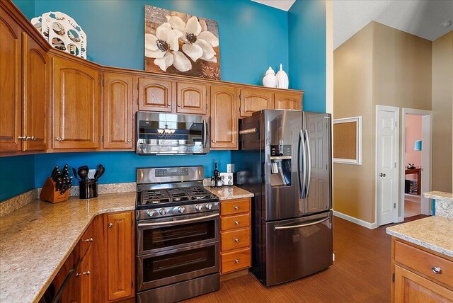 4144 Ridge Rd Unit 16, Stevensville, MI 49127 - kitchen featuring appliances with stainless steel finishes, wood finished floors, light countertops, and brown cabinets