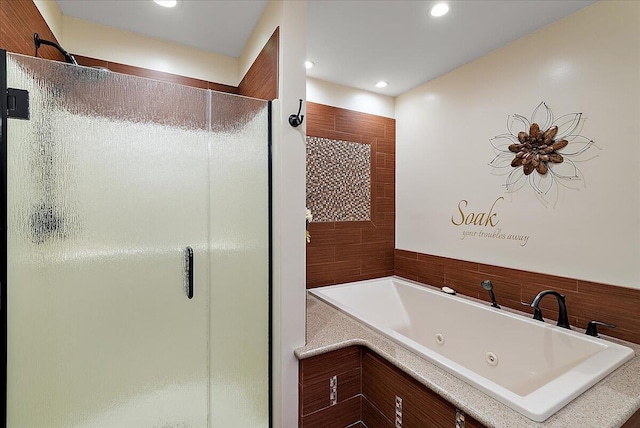 4144 Ridge Rd Unit 16, Stevensville, MI 49127 - bathroom with a shower stall, a tub with jets, and recessed lighting