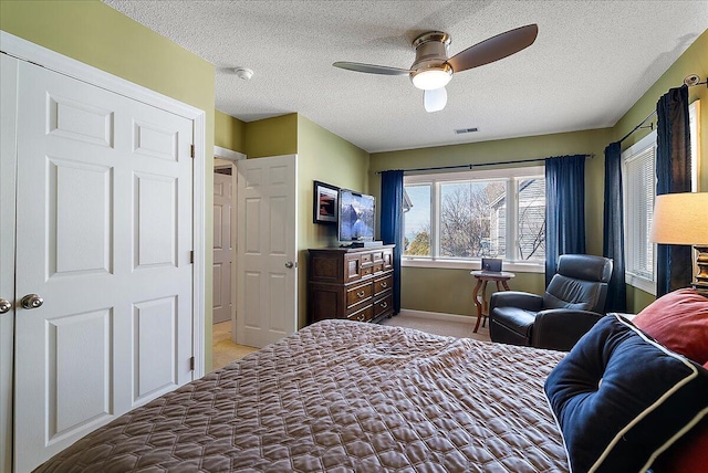 4144 Ridge Rd Unit 16, Stevensville, MI 49127 - bedroom with light carpet, a textured ceiling, baseboards, and ceiling fan