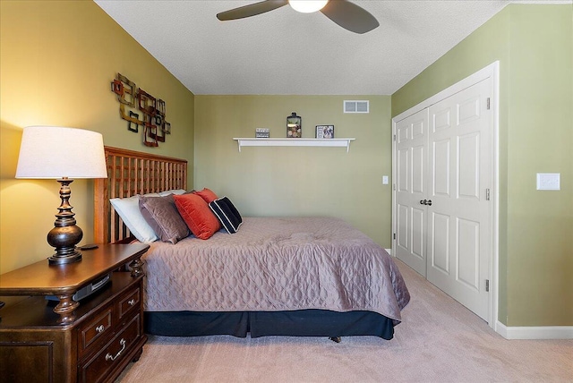 4144 Ridge Rd Unit 16, Stevensville, MI 49127 - bedroom with light colored carpet, baseboards, ceiling fan, a closet, and a textured ceiling