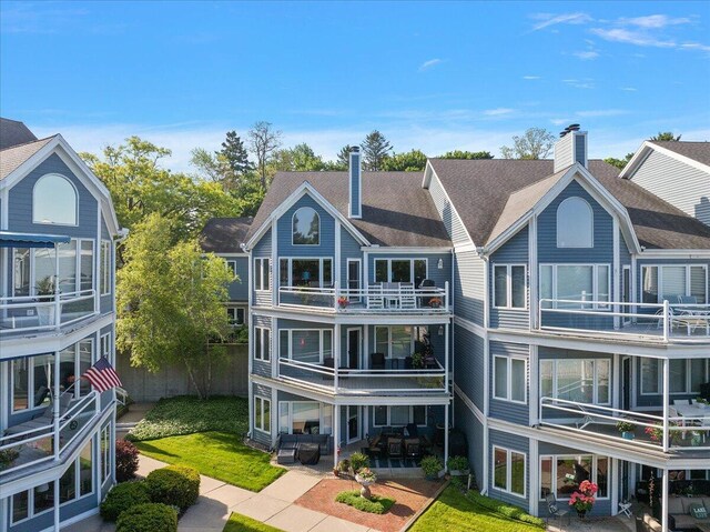 4144 Ridge Rd Unit 16, Stevensville, MI 49127 - rear view of house with a chimney, a patio, a balcony, and roof with shingles