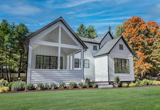 view of front of home with board and batten siding and a front yard