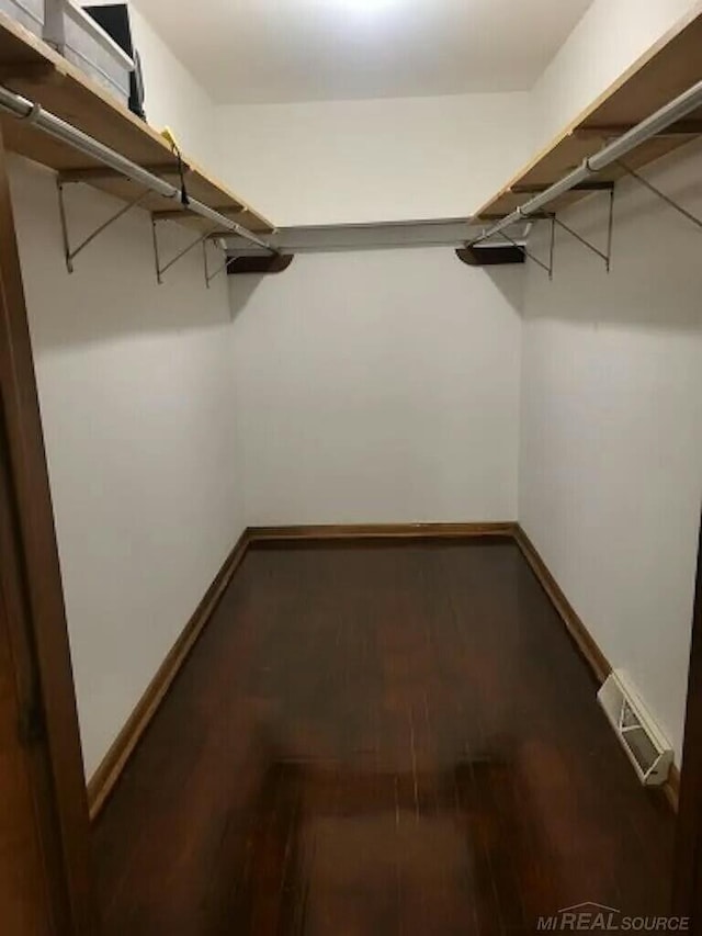 spacious closet featuring visible vents and wood finished floors