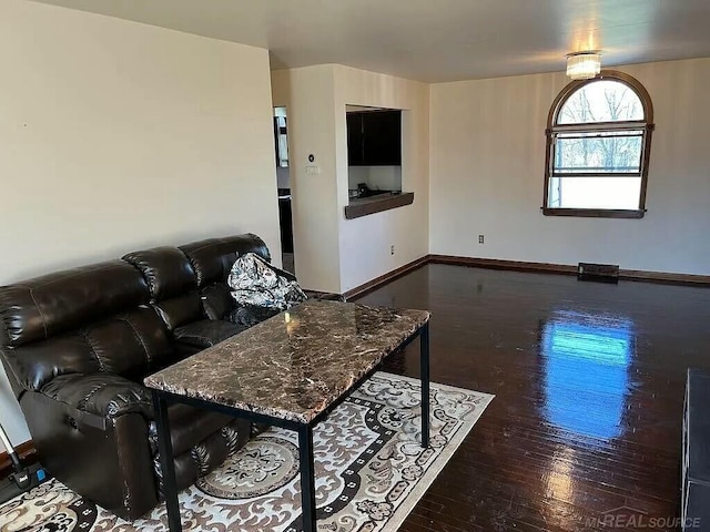 living area featuring wood finished floors and baseboards