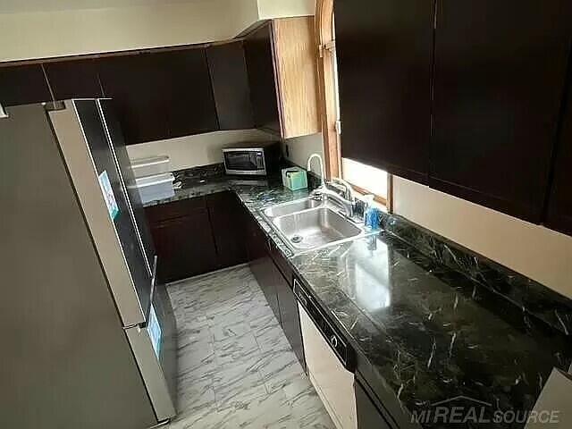 kitchen with marble finish floor, freestanding refrigerator, white dishwasher, a sink, and modern cabinets