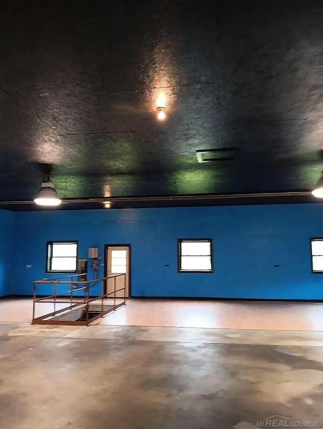 interior space featuring finished concrete flooring and a healthy amount of sunlight