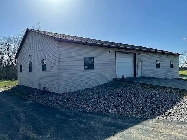 exterior space with driveway and an attached garage