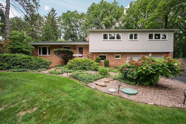 split level home with brick siding and a front lawn