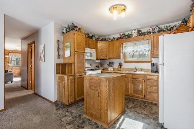 kitchen featuring white appliances, brown cabinetry, a kitchen island, light countertops, and a sink