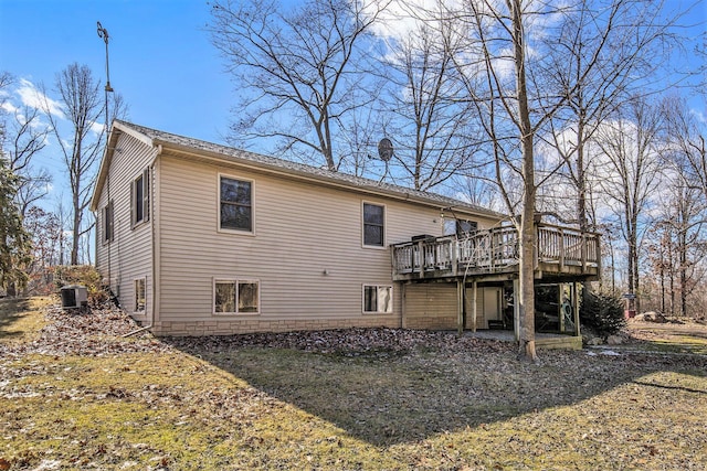 back of house featuring central air condition unit and a wooden deck