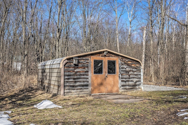 view of shed with a forest view