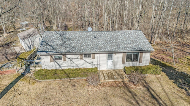 exterior space featuring roof with shingles