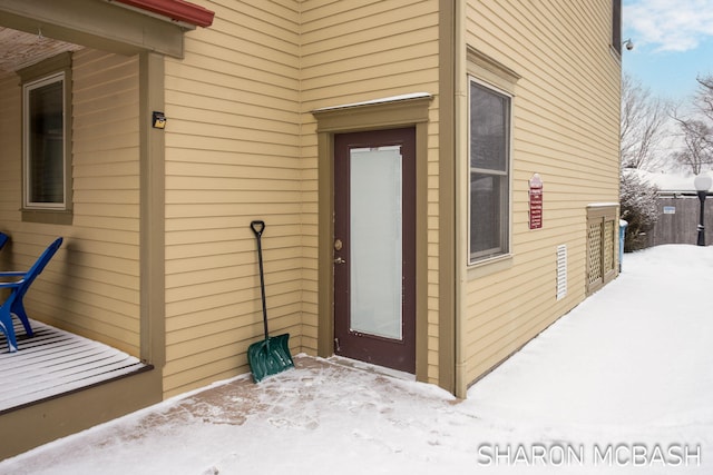 view of snow covered property entrance