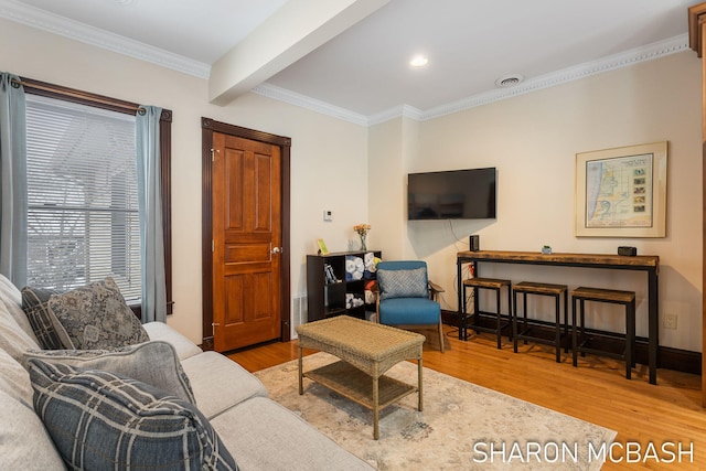 living room with visible vents, crown molding, baseboards, beam ceiling, and wood finished floors