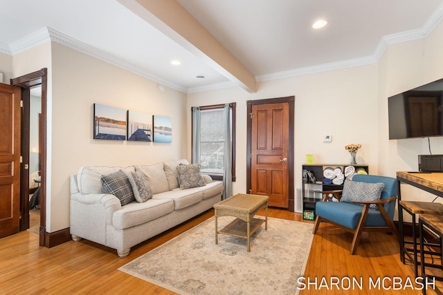 living room with ornamental molding, beamed ceiling, and light wood finished floors