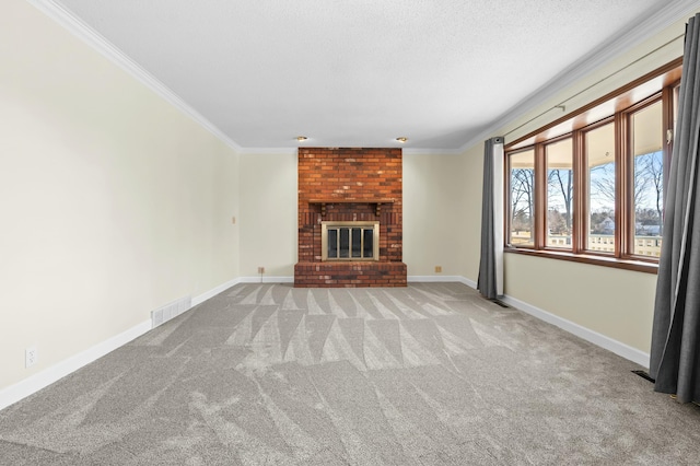 unfurnished living room featuring a brick fireplace, baseboards, visible vents, and crown molding