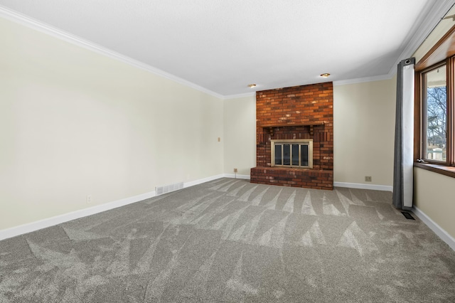 unfurnished living room with baseboards, visible vents, crown molding, carpet flooring, and a brick fireplace