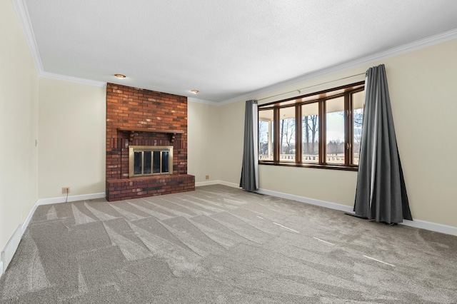 unfurnished living room with carpet, a brick fireplace, crown molding, and baseboards