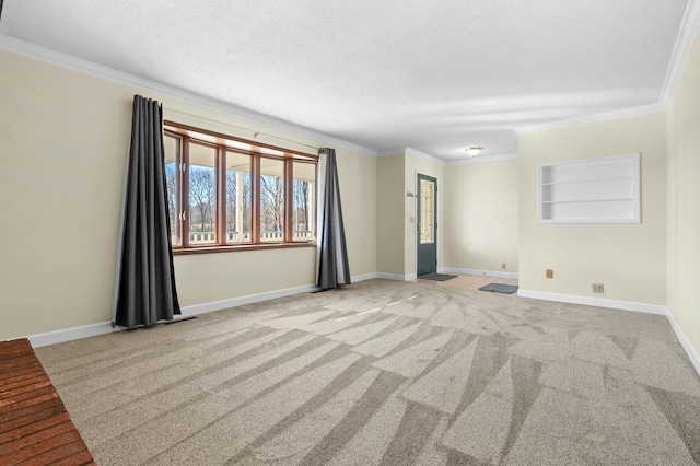 unfurnished room featuring crown molding, a textured ceiling, and baseboards