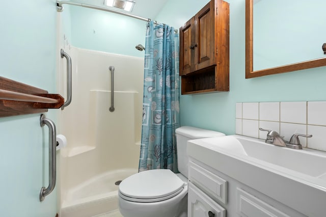 bathroom with toilet, vanity, backsplash, and a shower with shower curtain