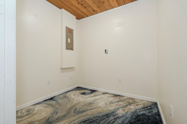 spare room featuring ornamental molding, wood ceiling, and baseboards