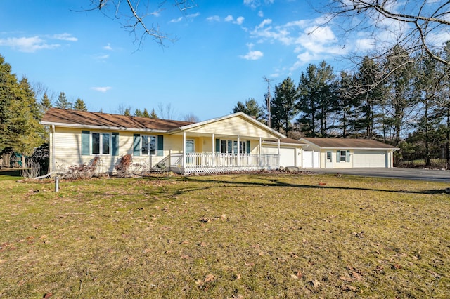 single story home featuring a front yard, covered porch, and an attached garage