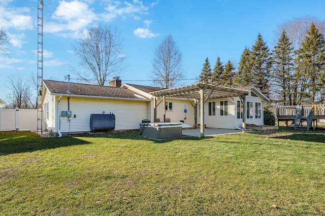 back of house featuring a hot tub, heating fuel, fence, a patio area, and a pergola