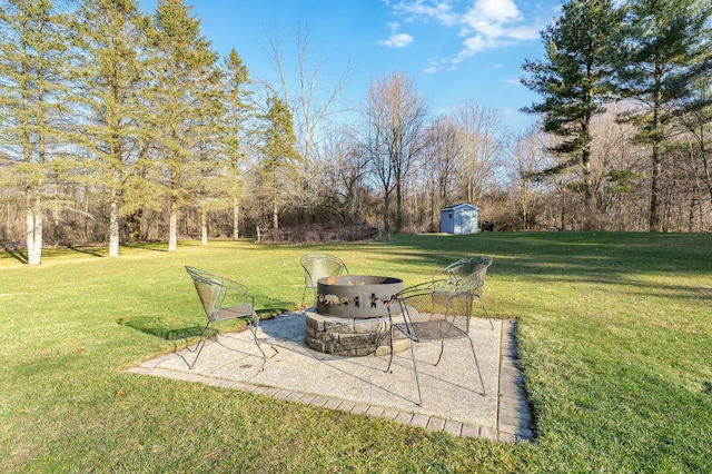 view of yard featuring an outbuilding, a patio area, and a storage shed