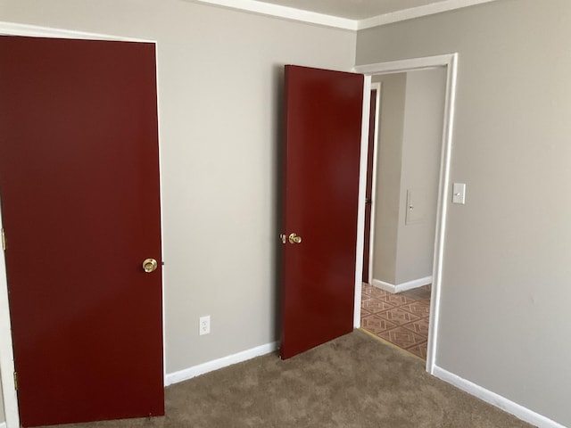 unfurnished bedroom with carpet flooring and baseboards