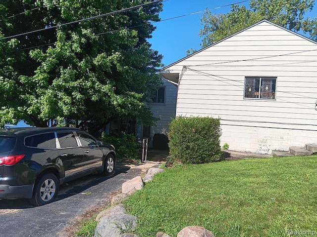 view of side of home with a lawn