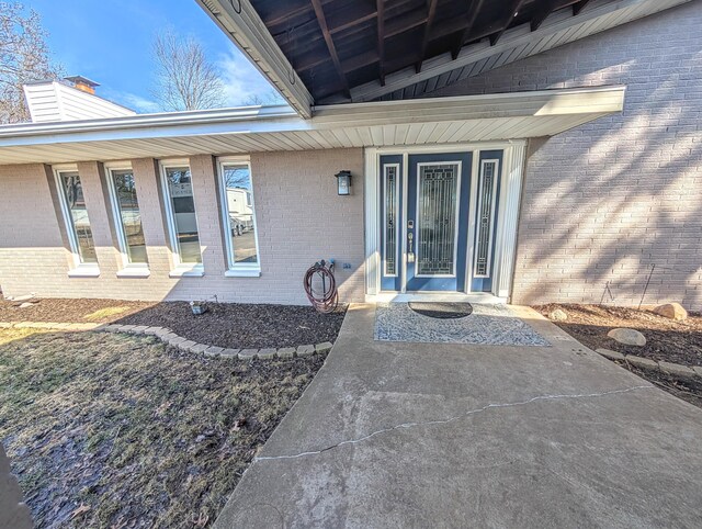 5007 S 42nd St, Climax, MI 49034 - property entrance with brick siding, a chimney, and covered porch