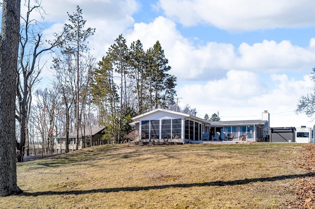 5007 S 42nd St, Climax, MI 49034 - rear view of property with a sunroom, a lawn, and a chimney
