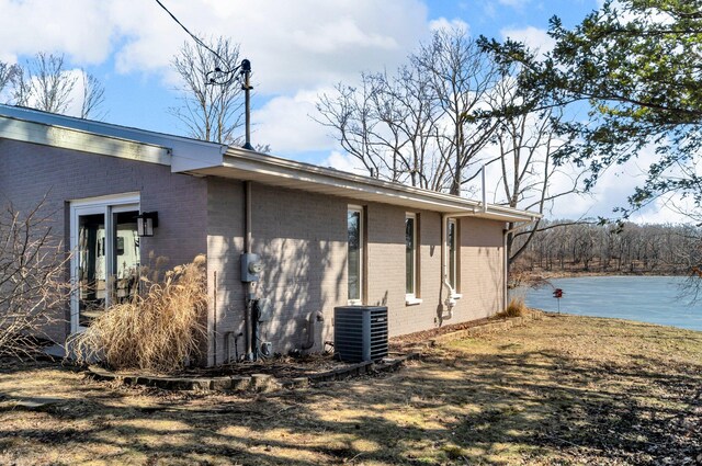 5007 S 42nd St, Climax, MI 49034 - view of property exterior featuring central AC, brick siding, and a water view