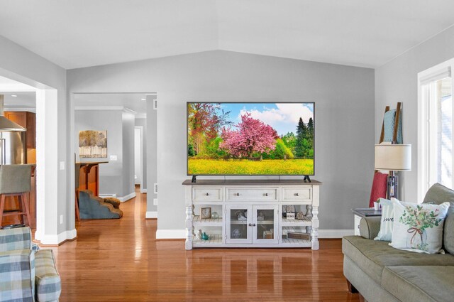 5007 S 42nd St, Climax, MI 49034 - living area featuring wood finished floors, vaulted ceiling, and baseboards