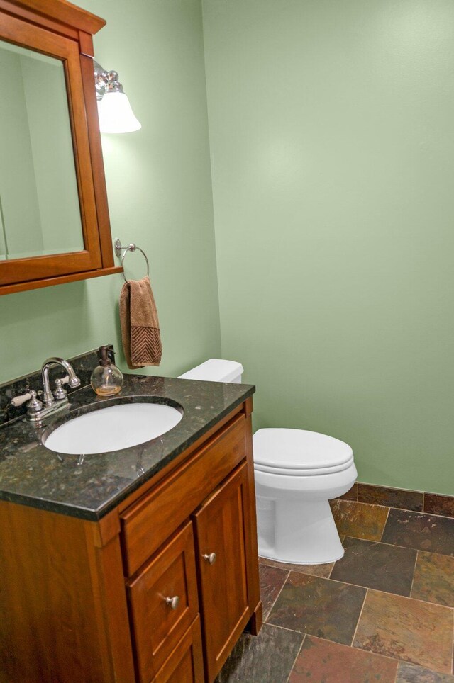 5007 S 42nd St, Climax, MI 49034 - half bath with stone tile floors, toilet, and vanity